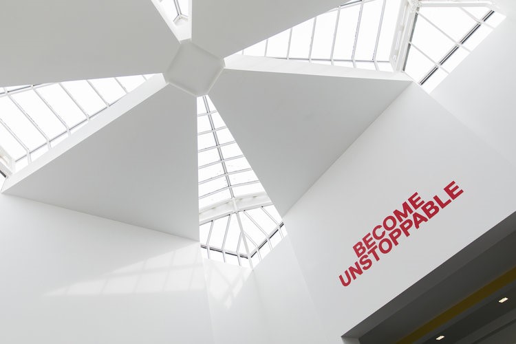 Signs in Salford business school. Become unstoppable